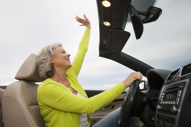 woman in convertible. alert1 medical alert systems
